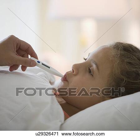 Girl having temperature taken View Large Photo Image Stock Image - Girl having temperature taken. Fotosearch
