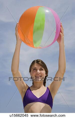 Girl holding beach ball View Large Photo Image Stock Photography - Girl holding beach ball. Fotosearch