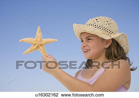 Girl holding starfish View Large Photo Image Stock Image - Girl holding starfish. Fotosearch
