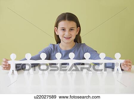 Stock Photo - Girl holding string of paper dolls. Fotosearch