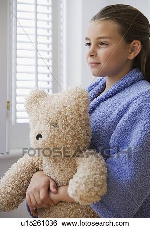 Girl holding teddy bear View Large Photo Image Stock Photograph - Girl holding teddy bear. Fotosearch