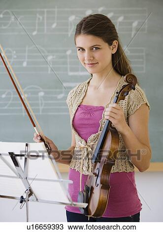 Stock Image - Girl holding violin. Fotosearch