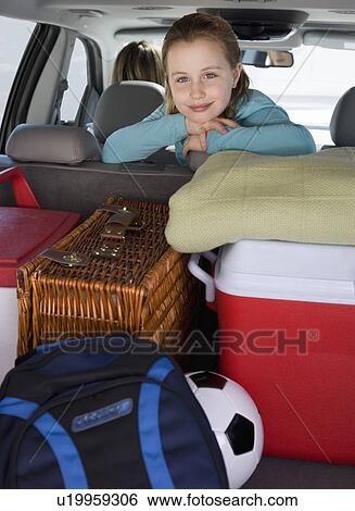 Girl in car with picnic supplies View Large Photo Image Stock Photograph - Girl in car with picnic supplies. Fotosearch