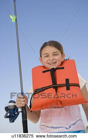 Girl in life jacket holding fishing pole View Large Photo Image Stock Photography - Girl in life jacket holding fishing pole. Fotosearch