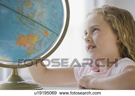 Stock Photo - Girl looking at globe. Fotosearch