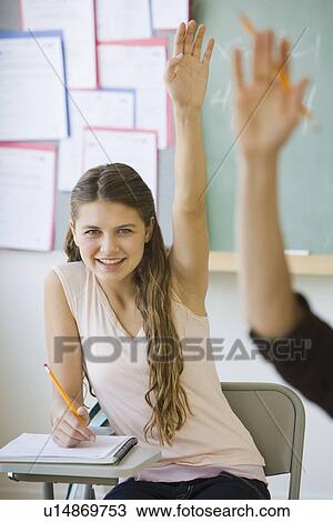 Girl raising hand in classroom View Large Photo Image Stock Image - Girl raising hand in classroom. Fotosearch
