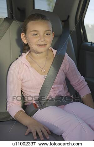 Girl sitting in backseat of car View Large Photo Image Stock Photo - Girl sitting in backseat of car. Fotosearch