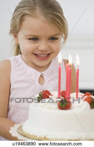 Girl smiling at birthday cake View Large Photo Image Stock Image - Girl smiling at birthday cake. Fotosearch
