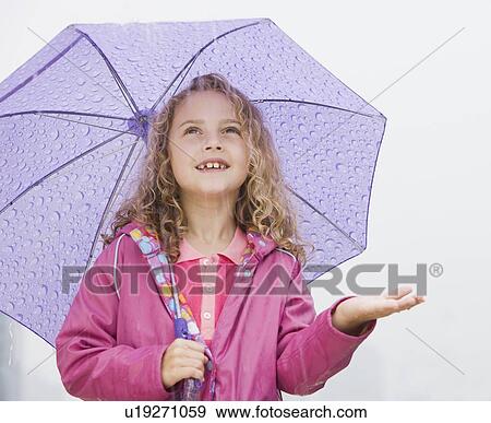 Girl standing under umbrella with hand out View Large Photo Image Stock Photo - Girl standing under umbrella with hand out. Fotosearch