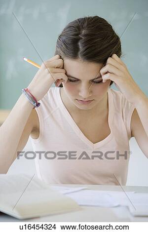 Picture - Girl studying in classroom. Fotosearch