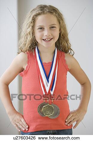 Stock Photograph - Girl wearing medals around neck. Fotosearch