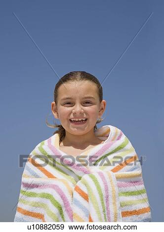 Stock Photo - Girl wrapped in beach towel. Fotosearch