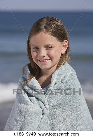 Stock Photo - Girl wrapped in beach towel. Fotosearch