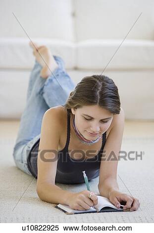 Stock Photography - Girl writing in journal. Fotosearch