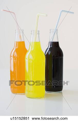 Stock Image - Glass soda bottles with straws. Fotosearch