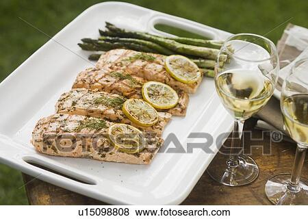 Stock Photo - Grilled fish and asparagus on platter. Fotosearch