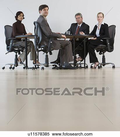 Stock Photography - Group of businesspeople having meeting. Fotosearch