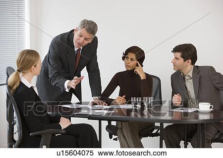 Stock Photography - Group of businesspeople in meeting. Fotosearch