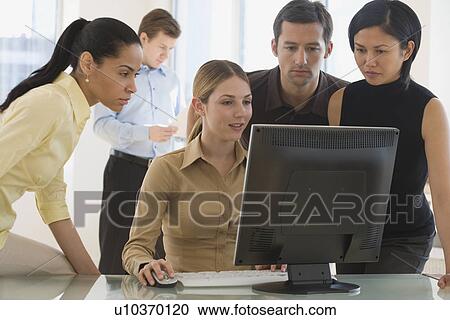 Group of businesspeople looking at computer View Large Photo Image Stock Image - Group of businesspeople looking at computer. Fotosearch