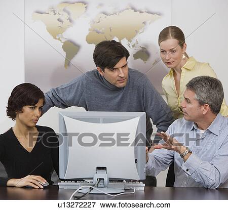 Group of businesspeople looking at computer View Large Photo Image Stock Photo - Group of businesspeople looking at computer. Fotosearch