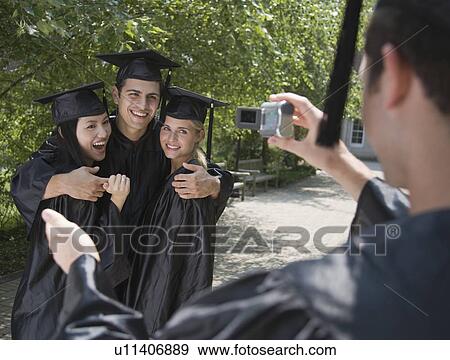 Stock Photo - Group of college graduates having photograph taken. Fotosearch