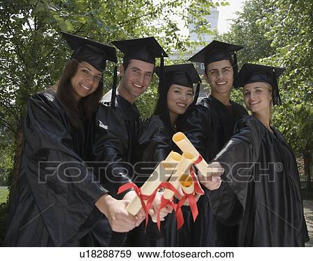 Group of college graduates holding diplomas View Large Photo Image Stock Photo - Group of college graduates holding diplomas. Fotosearch