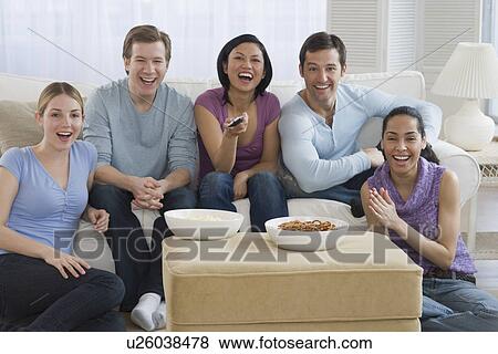 Group of friends watching television View Large Photo Image Stock Photo - Group of friends watching television. Fotosearch