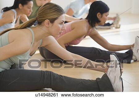 Stock Image - Group of people stretching. Fotosearch