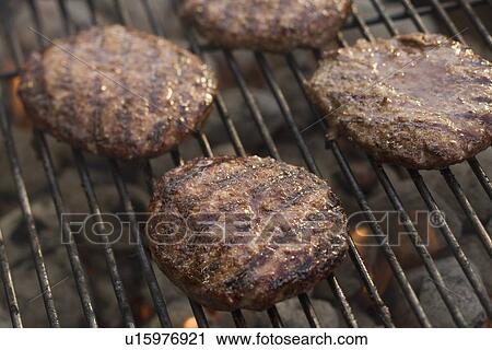 Hamburgers cooking on grill View Large Photo Image Stock Image - Hamburgers cooking on grill. Fotosearch