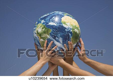 Picture - Hands holding up globe. Fotosearch
