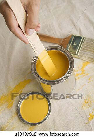 High angle view of man stirring paint in paint can View Large Photo Image Stock Image - High angle view of man stirring paint in paint can. Fotosearch