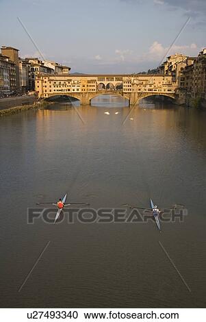 Stock Image - High angle view of people sculling, Ponte Vecchio, Florence, Italy. Fotosearch