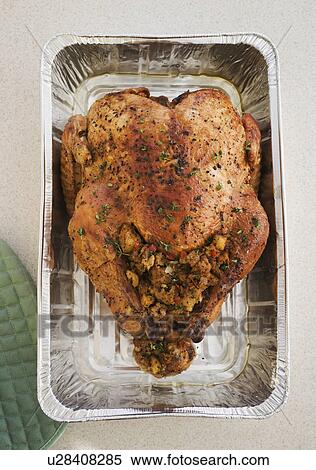 Stock Photography - High angle view of Thanksgiving turkey in pan. Fotosearch