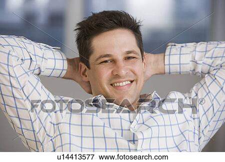 Stock Photo - Hispanic Man with hands behind head. Fotosearch