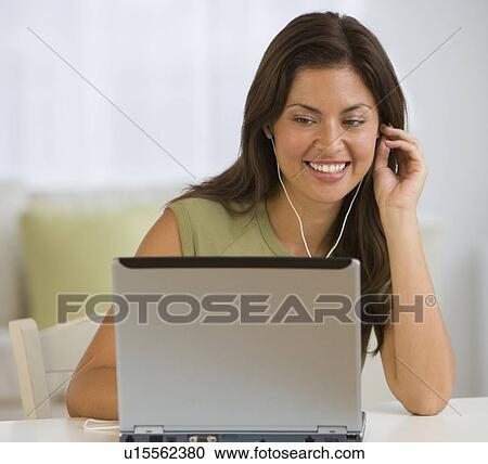 Hispanic woman listening to headphones View Large Photo Image Stock Image - Hispanic woman listening to headphones. Fotosearch