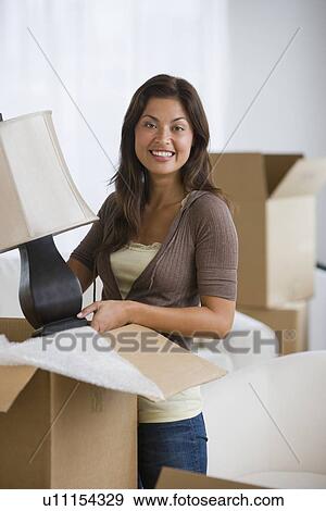 Hispanic woman packing moving box View Large Photo Image Stock Photo - Hispanic woman packing moving box. Fotosearch