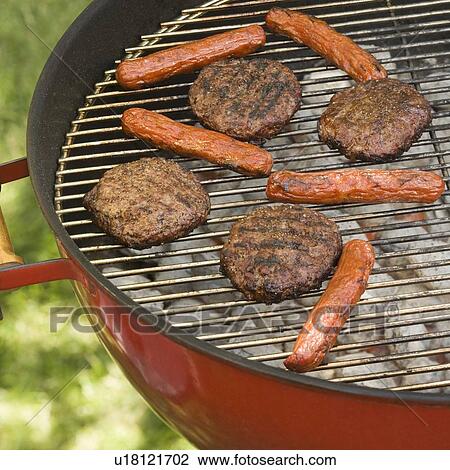 Hot dogs and hamburgers cooking on grill View Large Photo Image Stock Image - Hot dogs and hamburgers cooking on grill. Fotosearch
