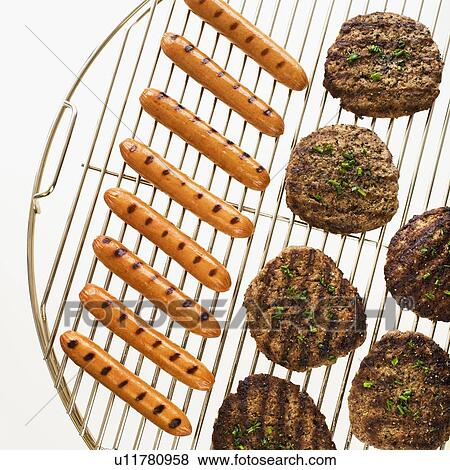 Hot dogs and hamburgers on grill View Large Photo Image Stock Photo - Hot dogs and hamburgers on grill. Fotosearch