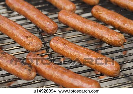 Hot dogs cooking on grill View Large Photo Image Picture - Hot dogs cooking on grill. Fotosearch