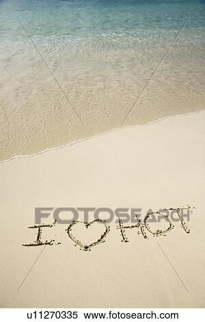 Stock Photography - I Love Hot written in sand. Fotosearch