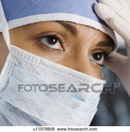 Stock Photo - Indian female doctor wearing surgical mask. Fotosearch