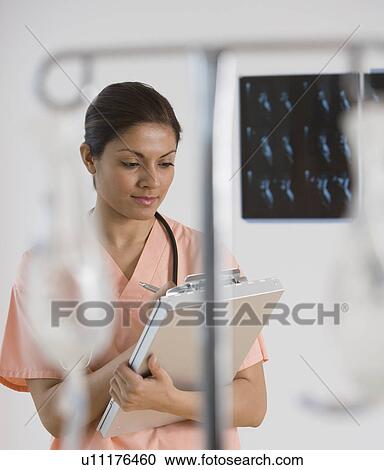 Indian female doctor writing on chart View Large Photo Image Stock Image - Indian female doctor writing on chart. Fotosearch
