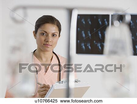 Indian female doctor writing on chart View Large Photo Image Stock Photography - Indian female doctor writing on chart. Fotosearch