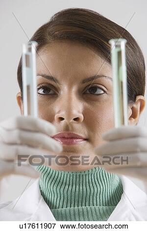 Stock Photo - Indian female scientist looking at vials. Fotosearch
