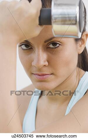 Indian woman holding dumbbell View Large Photo Image Stock Photography - Indian woman holding dumbbell. Fotosearch