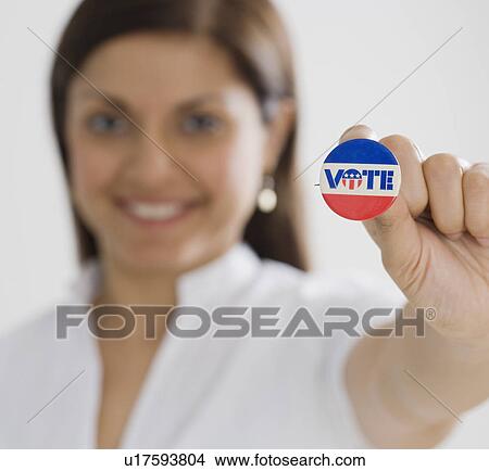 Indian woman holding up Vote pin View Large Photo Image Picture - Indian woman holding up Vote pin. Fotosearch