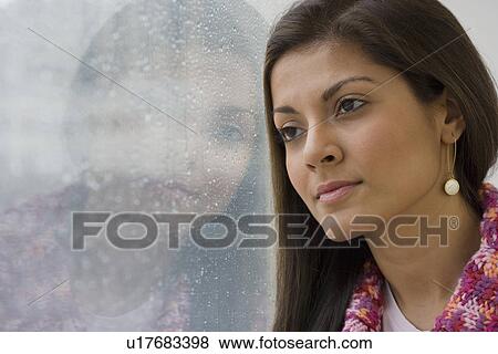 Indian woman leaning against window View Large Photo Image Stock Photo - Indian woman leaning against window. Fotosearch