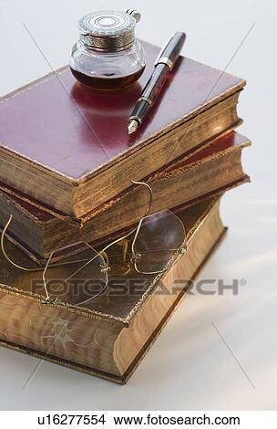Picture - Ink will and fountain pen on stack of books. Fotosearch