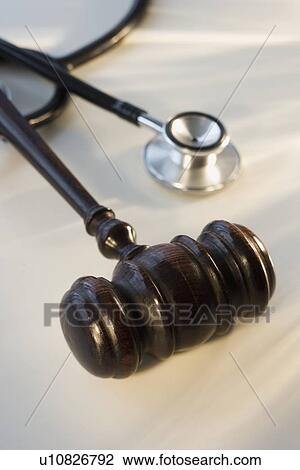 Stock Image - Judge’s gavel next to stethoscope. Fotosearch