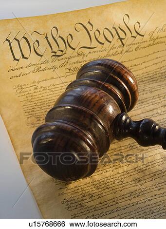 Stock Photograph - Judge’s gavel on the Constitution. Fotosearch
